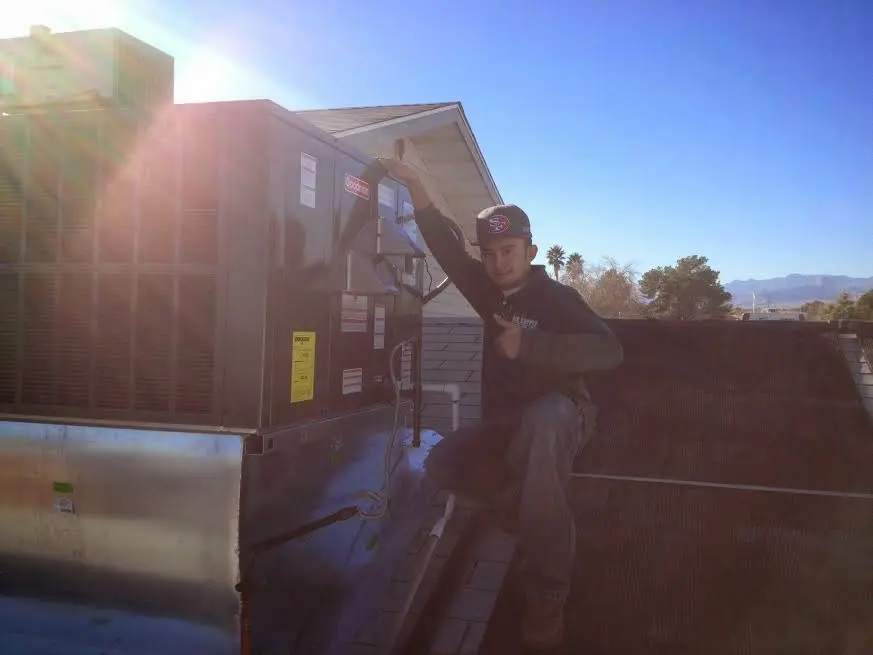 HVAC technician performing HVAC Inspection on a rooftop unit in Carlisle